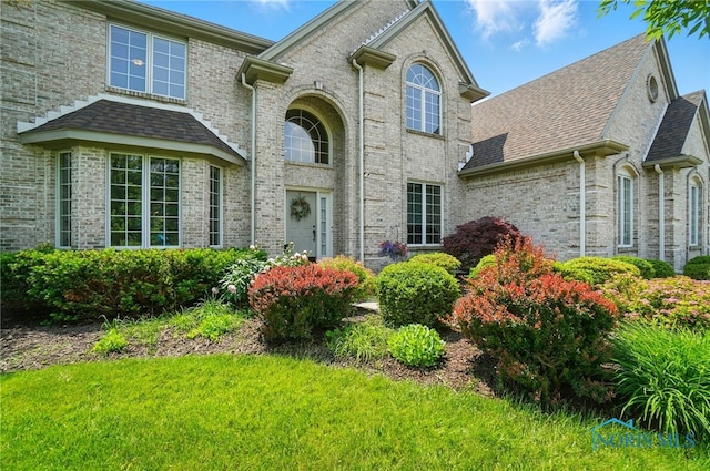 7433 Valhalla Dr, Maumee, OH 43537 - view of front facade with roof with shingles and brick siding