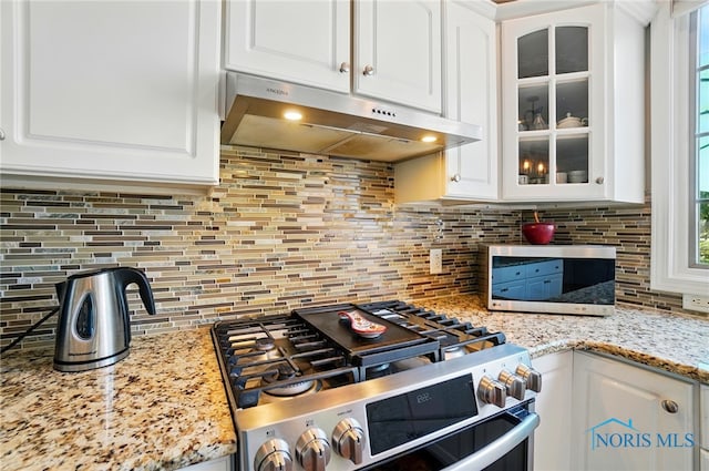7433 Valhalla Dr, Maumee, OH 43537 - kitchen featuring under cabinet range hood, gas range, and white cabinets