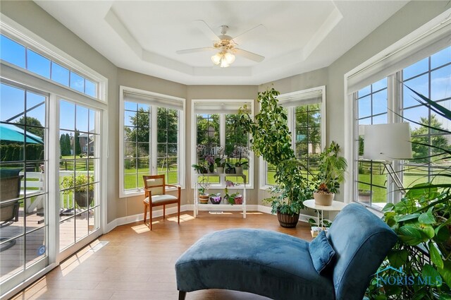 7433 Valhalla Dr, Maumee, OH 43537 - sunroom with a raised ceiling, wood finished floors, and baseboards