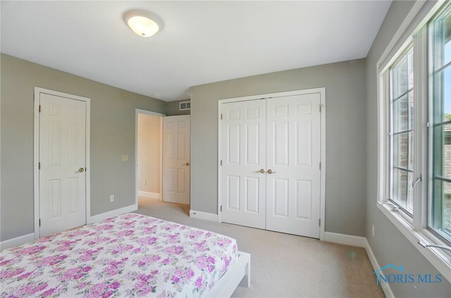 7433 Valhalla Dr, Maumee, OH 43537 - bedroom featuring baseboards, light carpet, and a closet