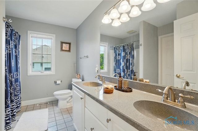 7433 Valhalla Dr, Maumee, OH 43537 - full bath with healthy amount of natural light, double vanity, baseboards, and toilet