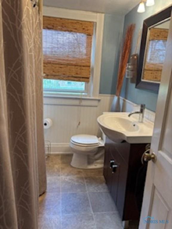 443 E 4th St, Ottawa, OH 45875 - bathroom with vanity, toilet, and wainscoting