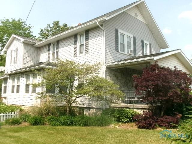 443 E 4th St, Ottawa, OH 45875 - view of side of home featuring a lawn and covered porch