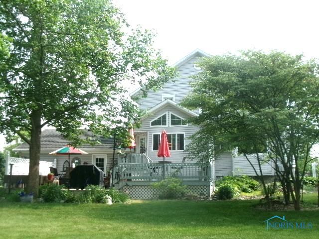 443 E 4th St, Ottawa, OH 45875 - view of front of home with a deck and a front lawn