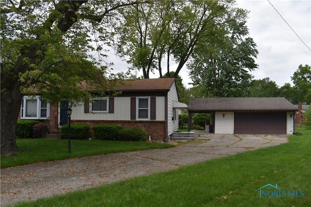 38 N Melody Ln, Waterville, OH 43566 - view of front of home featuring brick siding, an outdoor structure, and a front lawn