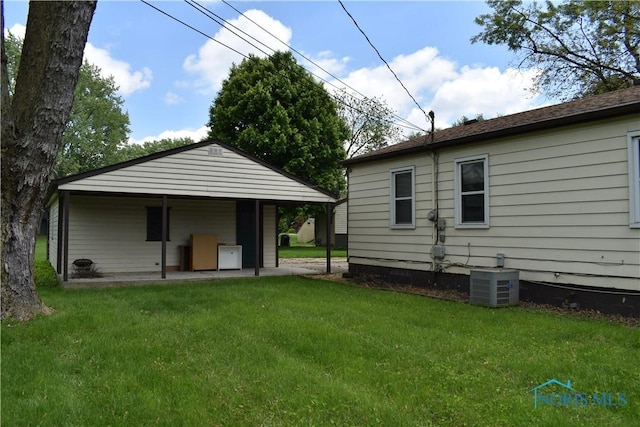 38 N Melody Ln, Waterville, OH 43566 - rear view of house with cooling unit and a lawn