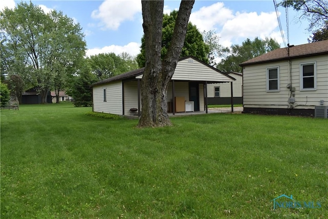 38 N Melody Ln, Waterville, OH 43566 - back of property featuring a lawn and central AC unit