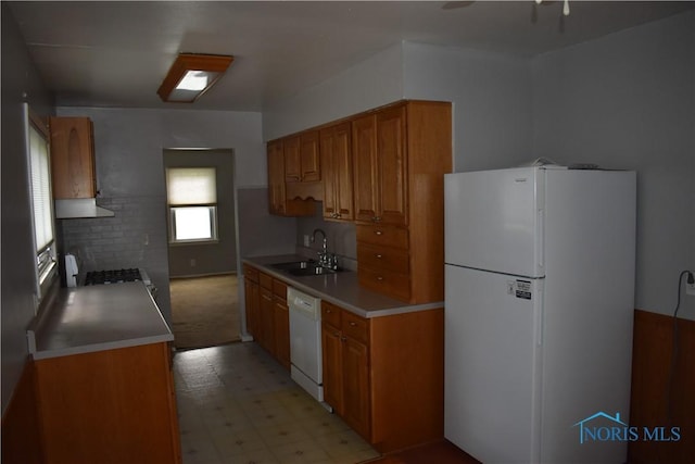 38 N Melody Ln, Waterville, OH 43566 - kitchen featuring white appliances, a sink, brown cabinets, light floors, and light countertops