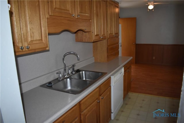 38 N Melody Ln, Waterville, OH 43566 - kitchen with dishwasher, a sink, a wainscoted wall, a ceiling fan, and light flooring