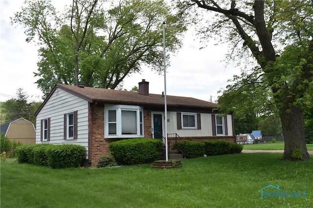 38 N Melody Ln, Waterville, OH 43566 - ranch-style home with brick siding, a chimney, and a front lawn