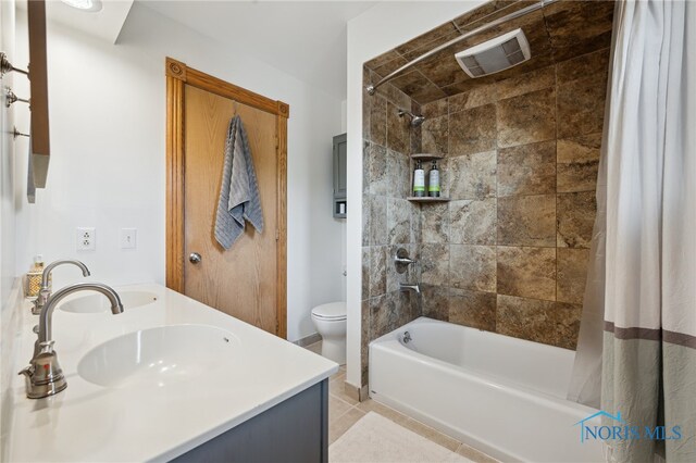 2546 Redfox Dr, Toledo, OH 43611 - bathroom with shower / bathtub combination with curtain, toilet, double vanity, tile patterned flooring, and baseboards