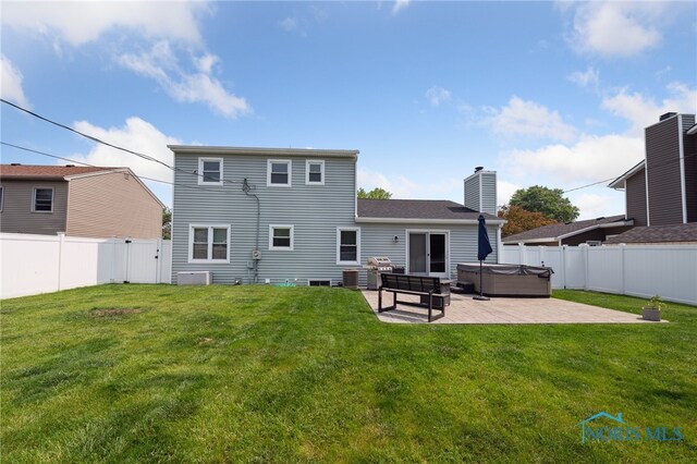 2546 Redfox Dr, Toledo, OH 43611 - back of house with a hot tub, a patio, a chimney, and central AC unit