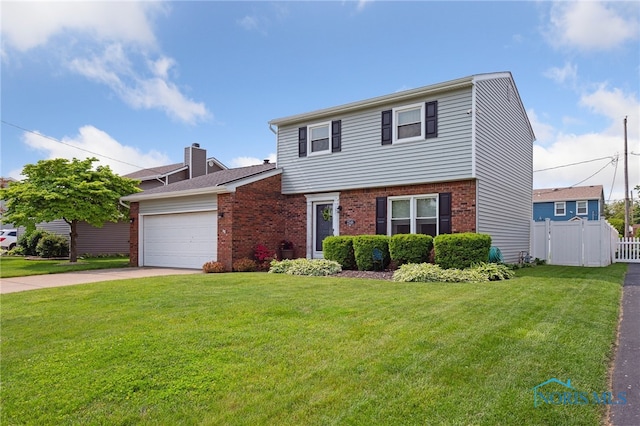 2546 Redfox Dr, Toledo, OH 43611 - colonial-style house with brick siding, a garage, and driveway