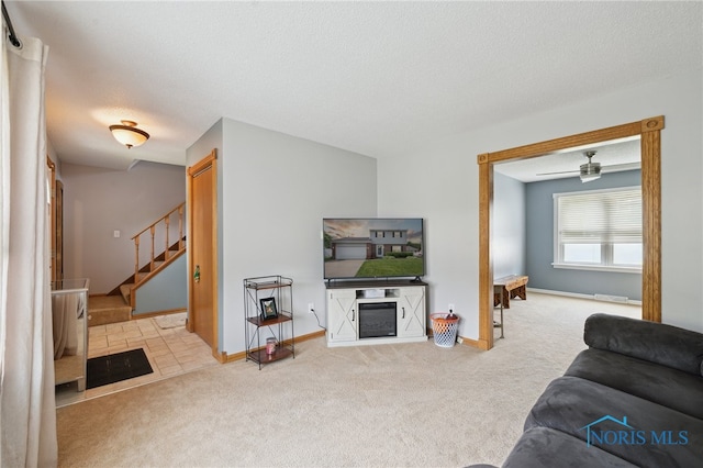 2546 Redfox Dr, Toledo, OH 43611 - living area featuring carpet flooring, stairs, a textured ceiling, and baseboards