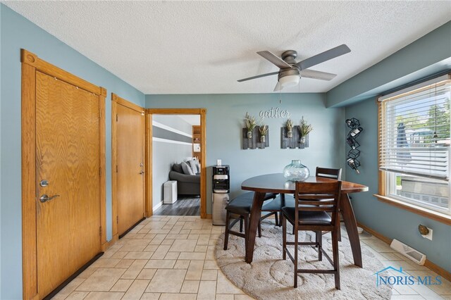 2546 Redfox Dr, Toledo, OH 43611 - dining area featuring a textured ceiling, ceiling fan, baseboards, and radiator heating unit