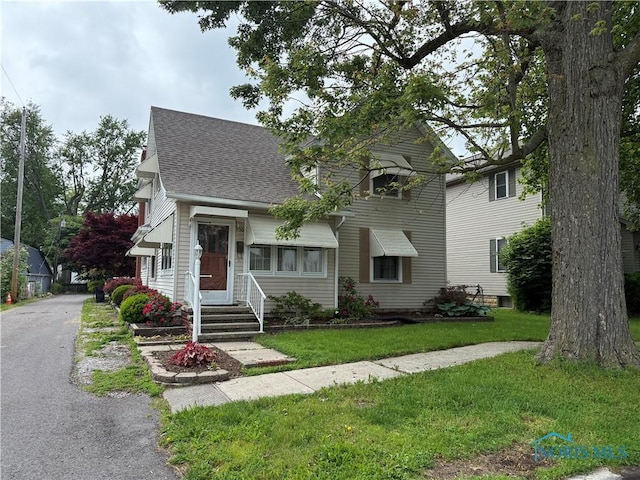 700 Franklin Ave, Findlay, OH 45840 - view of front of house with roof with shingles, a front yard, and entry steps