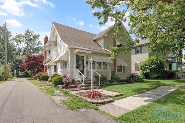 700 Franklin Ave, Findlay, OH 45840 - view of front of house with a front yard, a chimney, and roof with shingles