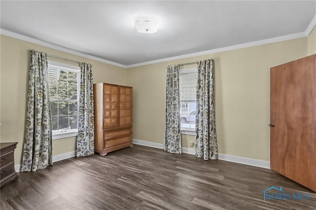 700 Franklin Ave, Findlay, OH 45840 - unfurnished bedroom with crown molding, dark wood-style floors, and baseboards