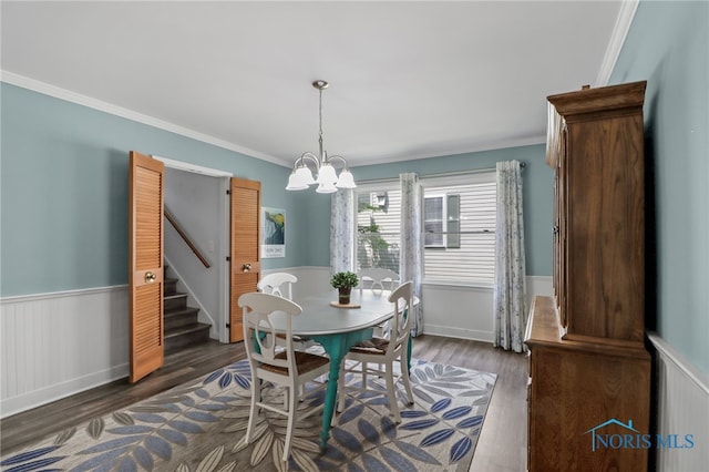 700 Franklin Ave, Findlay, OH 45840 - dining room with a wainscoted wall, wood finished floors, a chandelier, ornamental molding, and stairway
