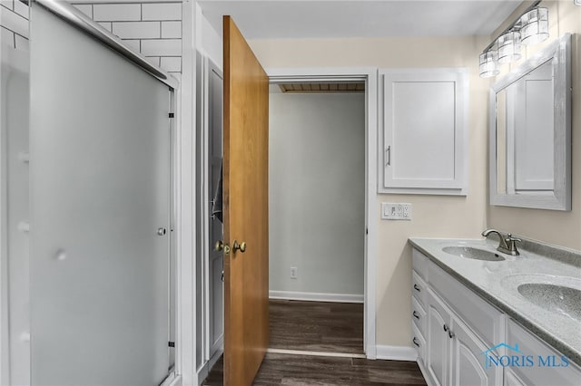700 Franklin Ave, Findlay, OH 45840 - full bath with double vanity, wood finished floors, baseboards, and a shower stall