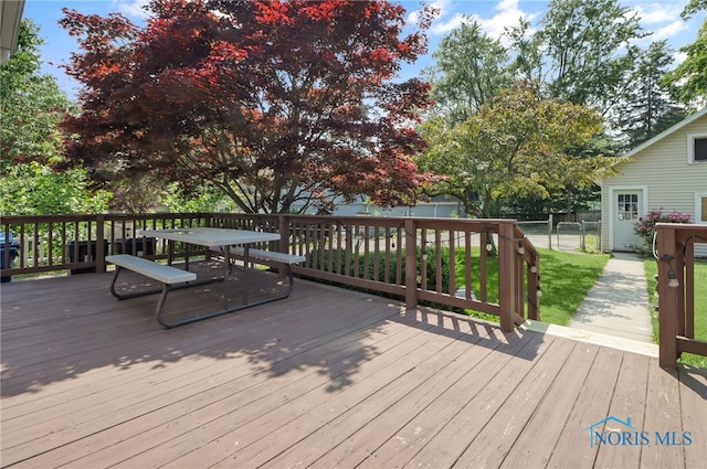 700 Franklin Ave, Findlay, OH 45840 - wooden terrace featuring a fenced backyard, outdoor dining area, and a gate