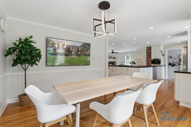 2829 Pembroke Rd, Ottawa Hills, OH 43606 - dining space featuring light wood finished floors, baseboards, recessed lighting, and ornamental molding