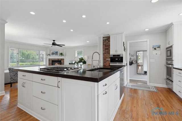 2829 Pembroke Rd, Ottawa Hills, OH 43606 - kitchen with a sink, appliances with stainless steel finishes, ceiling fan, a warming drawer, and dark countertops