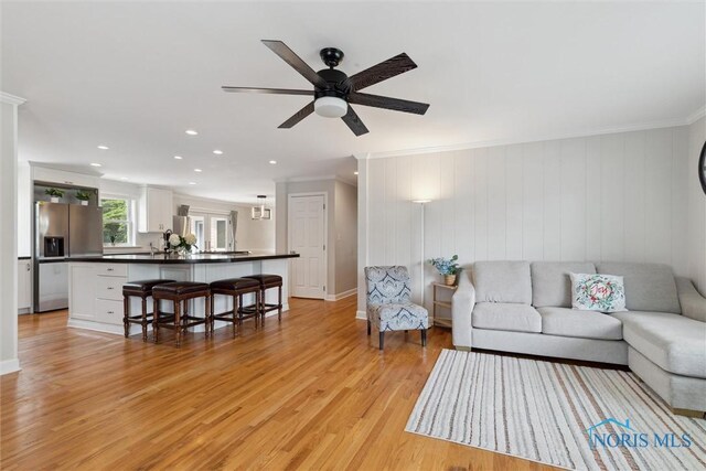 2829 Pembroke Rd, Ottawa Hills, OH 43606 - living room with crown molding, light wood-style flooring, recessed lighting, ceiling fan, and baseboards