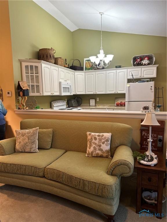 1245 Countryside Dr, Findlay, OH 45840 - living room featuring a chandelier, carpet floors, and high vaulted ceiling