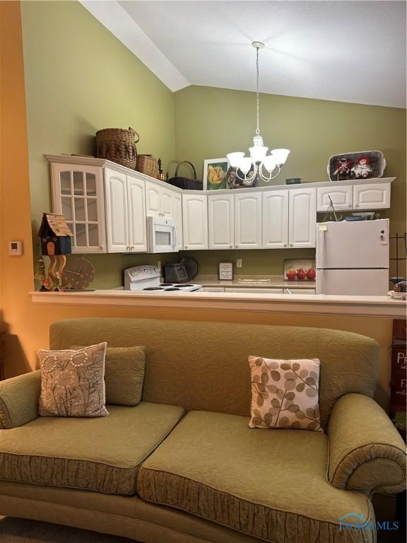 1245 Countryside Dr, Findlay, OH 45840 - kitchen with white appliances, vaulted ceiling, white cabinets, a chandelier, and hanging light fixtures