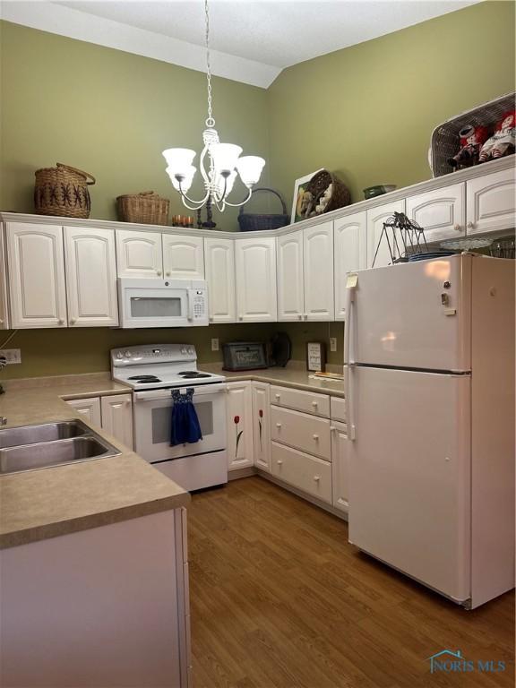 1245 Countryside Dr, Findlay, OH 45840 - kitchen featuring white appliances, a sink, white cabinetry, a chandelier, and decorative light fixtures