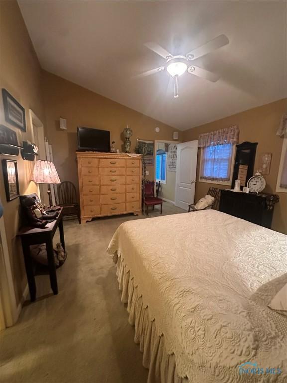 1245 Countryside Dr, Findlay, OH 45840 - bedroom with light carpet, lofted ceiling, and ceiling fan