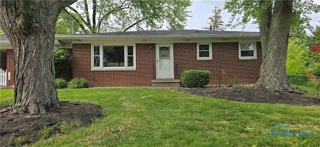 1050 Schreier Rd, Rossford, OH 43460 - view of front of home featuring brick siding, a front yard, and entry steps