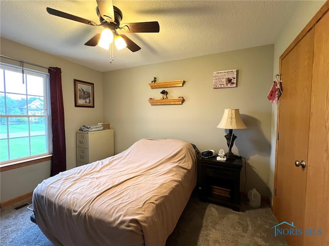 606 Polaris Dr, Upper Sandusky, OH 43351 - carpeted bedroom featuring a ceiling fan, a textured ceiling, and baseboards