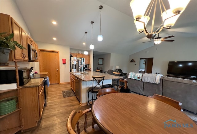 606 Polaris Dr, Upper Sandusky, OH 43351 - dining area featuring vaulted ceiling, ceiling fan, light wood-style flooring, recessed lighting, and a chandelier