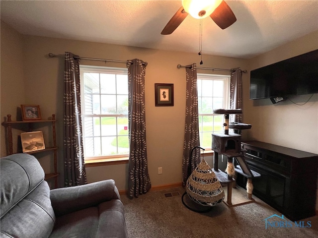 606 Polaris Dr, Upper Sandusky, OH 43351 - carpeted living room with a ceiling fan and baseboards