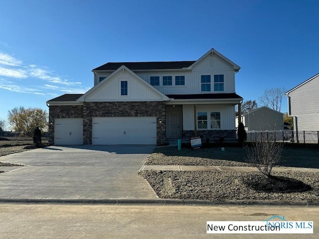 936 Darter Dr, Bowling Green, OH 43402 - view of front of home with stone siding, concrete driveway, and an attached garage
