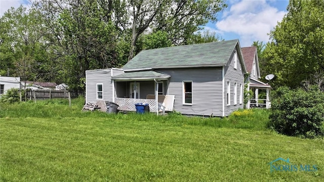 678 Lorain St, Toledo, OH 43609 - back of house featuring a yard and a shingled roof