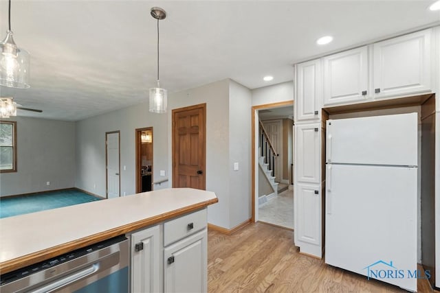 431 Hertford Ct, Maumee, OH 43537 - kitchen with freestanding refrigerator, stainless steel dishwasher, white cabinets, decorative light fixtures, and light wood-style floors