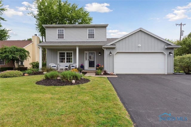 431 Hertford Ct, Maumee, OH 43537 - traditional-style home featuring driveway, a garage, a front yard, a porch, and roof with shingles