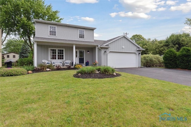 431 Hertford Ct, Maumee, OH 43537 - traditional-style house featuring a garage, covered porch, asphalt driveway, and a front yard