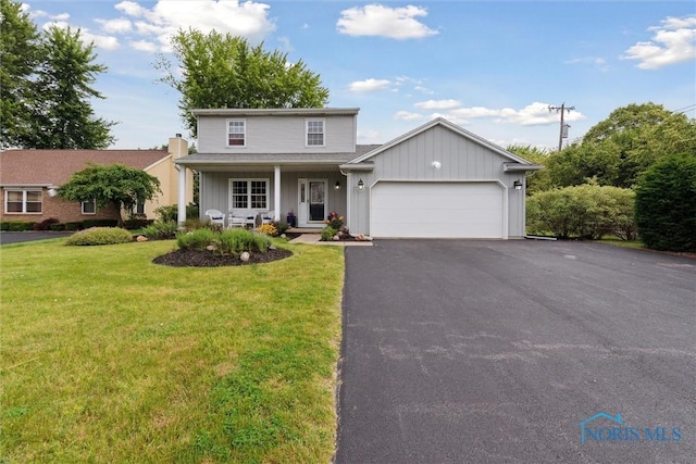 431 Hertford Ct, Maumee, OH 43537 - traditional-style house featuring board and batten siding, an attached garage, a front yard, asphalt driveway, and covered porch