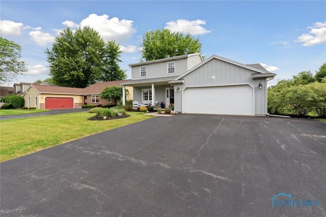 431 Hertford Ct, Maumee, OH 43537 - traditional-style home featuring board and batten siding, an attached garage, asphalt driveway, a front yard, and covered porch
