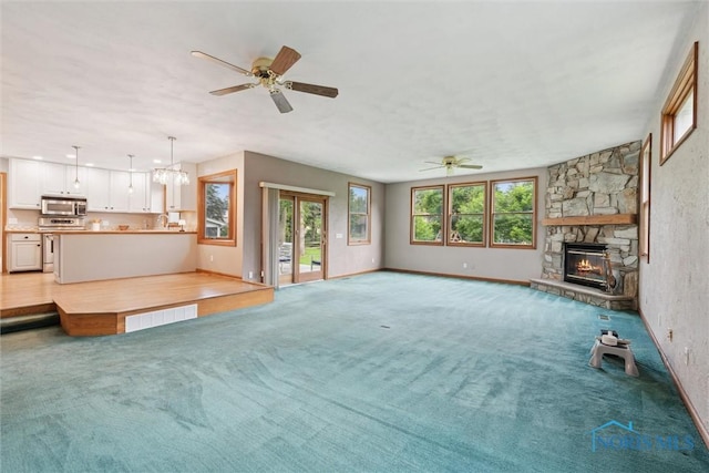 431 Hertford Ct, Maumee, OH 43537 - unfurnished living room featuring ceiling fan, a fireplace, and light carpet