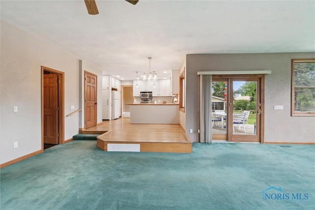 431 Hertford Ct, Maumee, OH 43537 - unfurnished living room with a chandelier, a ceiling fan, and light colored carpet