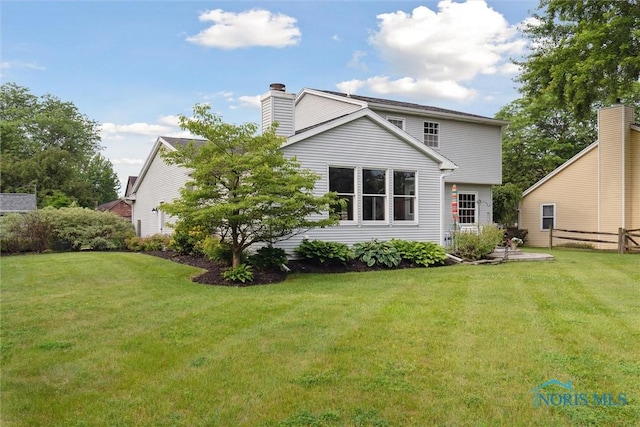 431 Hertford Ct, Maumee, OH 43537 - back of property with a yard and a chimney