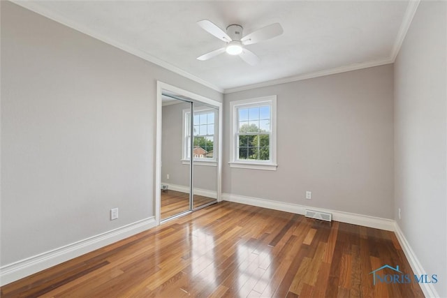 431 Hertford Ct, Maumee, OH 43537 - unfurnished bedroom featuring wood finished floors, crown molding, a closet, and a ceiling fan