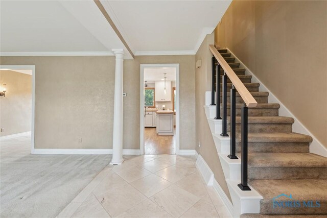 431 Hertford Ct, Maumee, OH 43537 - entrance foyer featuring ornamental molding, decorative columns, stairs, and light tile patterned floors