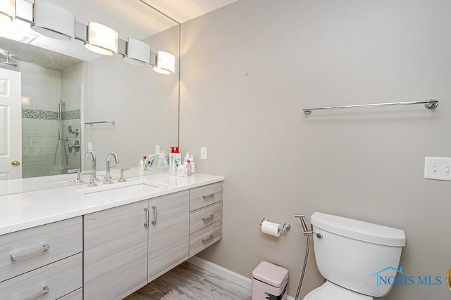 7559 Peachtree Ln, Sylvania, OH 43560 - bathroom with vanity, toilet, a tile shower, and baseboards
