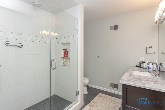 7559 Peachtree Ln, Sylvania, OH 43560 - full bathroom featuring vanity, a stall shower, toilet, and baseboards